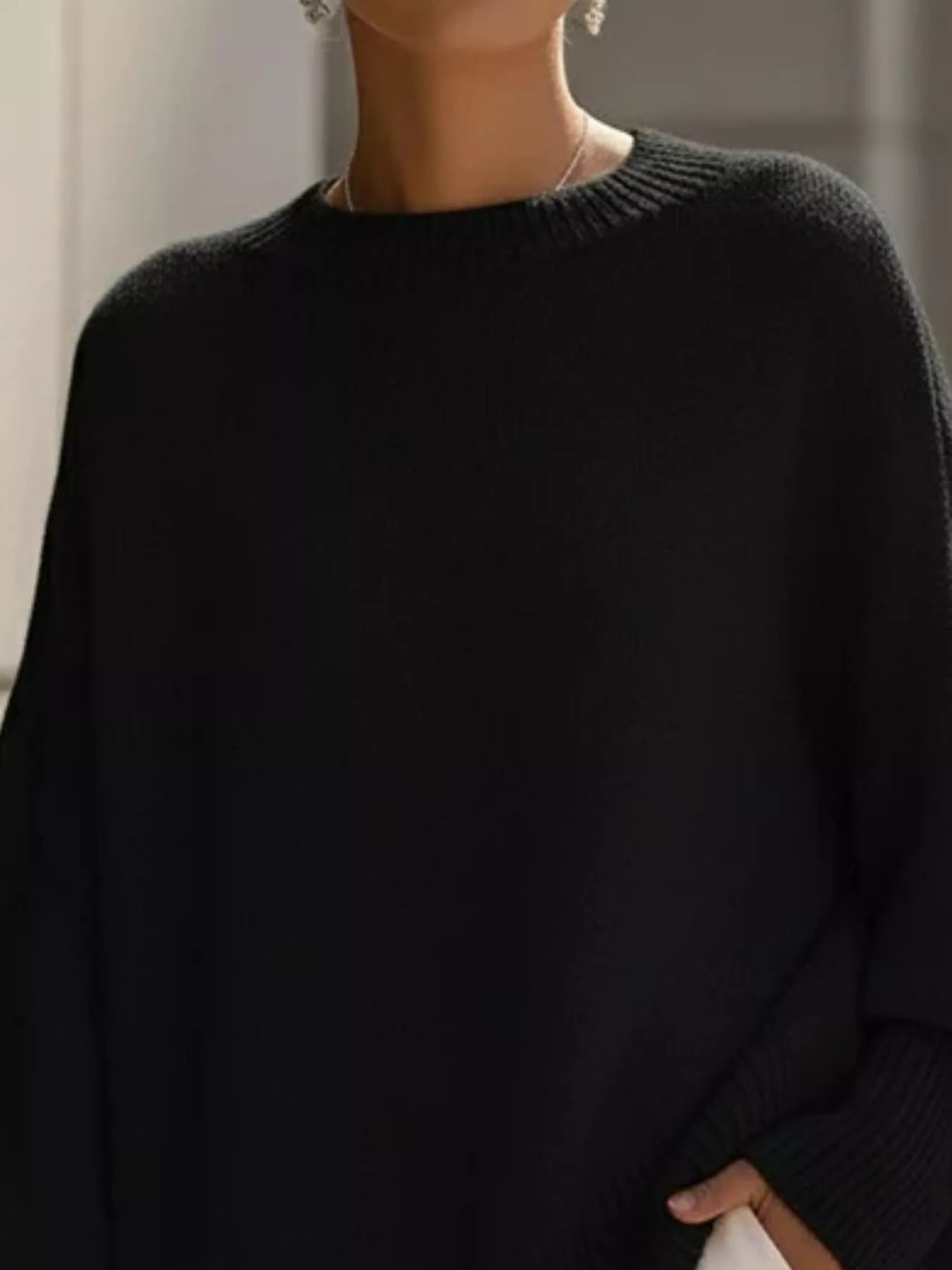 Black oversized batwing sleeve knit sweater with ribbed crew neck