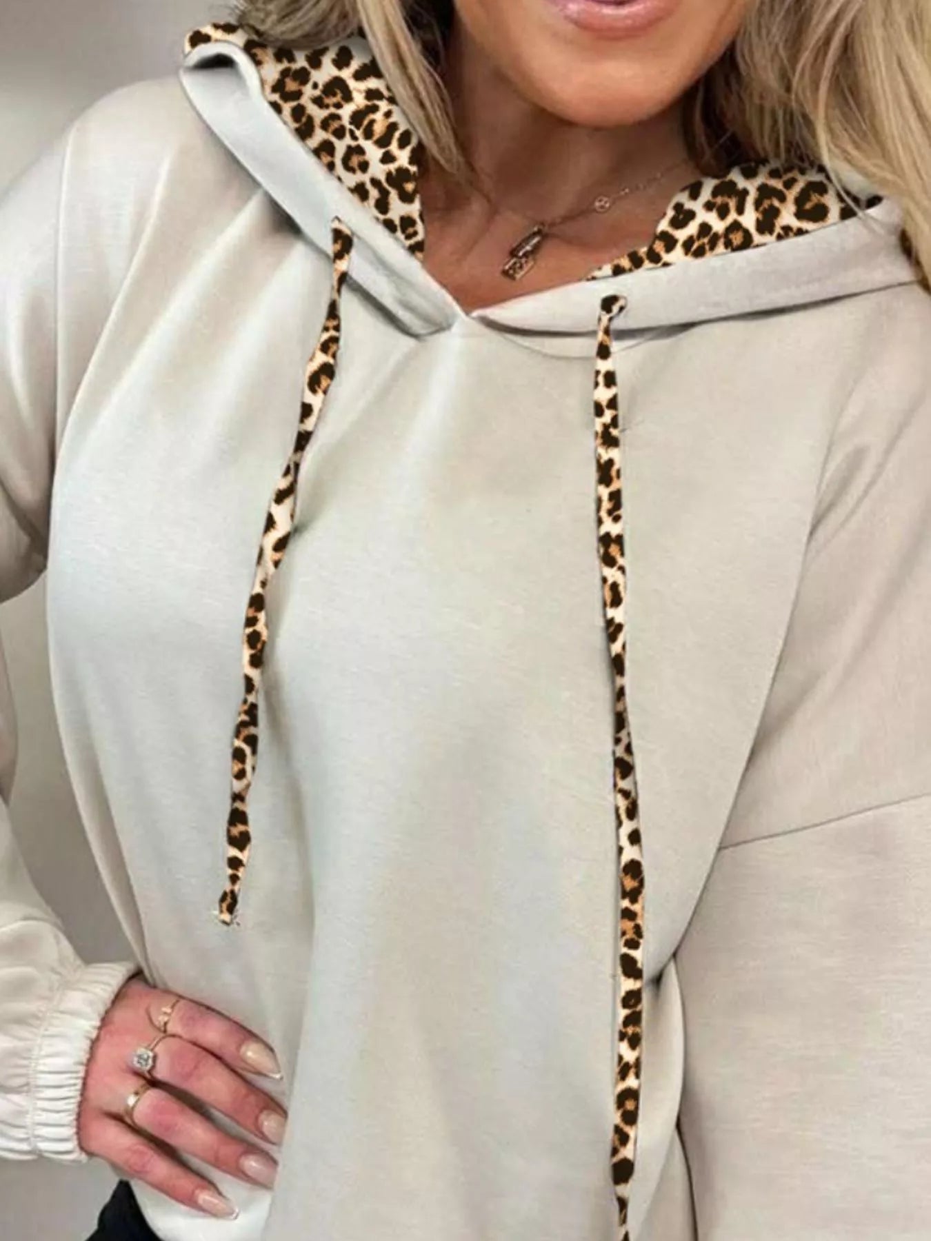 Beige long sleeve hoodie with leopard trim hood lining and drawstrings