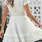 Tie-front mini dress in flowing white chiffon with smocked waist
