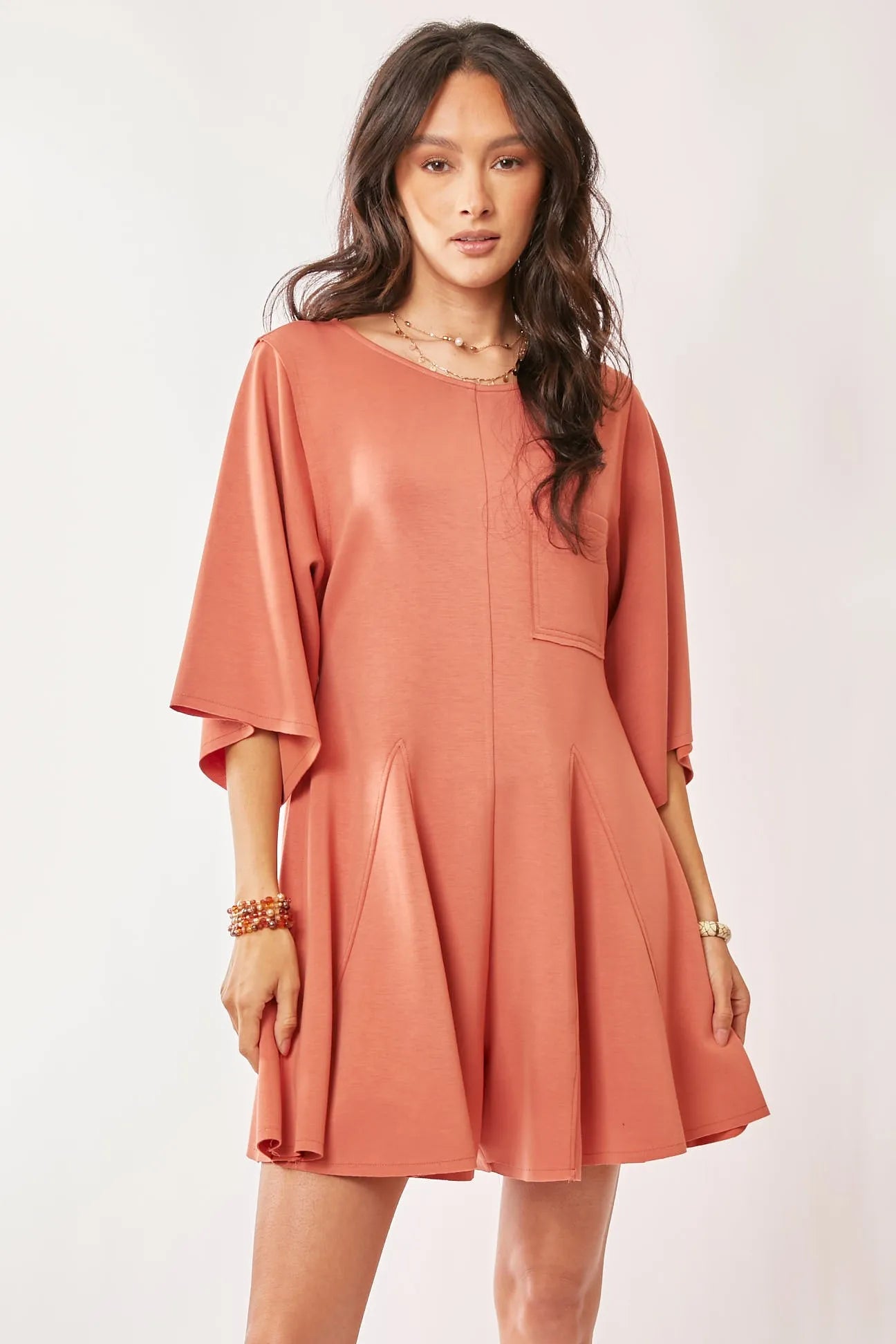 Davi & Dani soft peach satin romper with draped sleeves, ties back, flared skirt