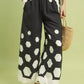 Black Umgee hexagon print wide-leg pants with scalloped hem