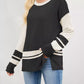 Black and cream color-blocked long-sleeve Color Block Side Slit Sweater with ribbed texture, striped cuffs and hem