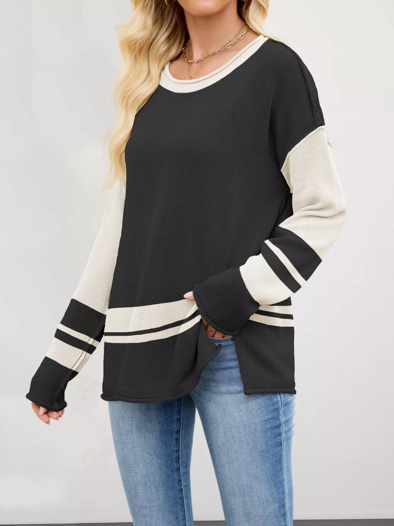 Black and cream color-blocked long-sleeve Color Block Side Slit Sweater with ribbed texture, striped cuffs and hem