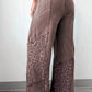 Brown leopard-print wide-leg pants with relaxed distressed fabric