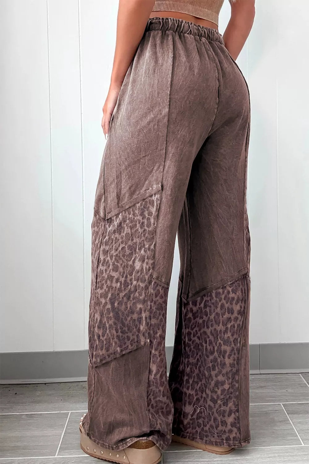 Brown leopard-print wide-leg pants with relaxed distressed fabric