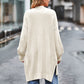 Cream-colored oversized waffle-knit cardigan with textured weave and side slits