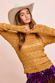 Mustard yellow textured sweater with scalloped hem and wide-brimmed hat