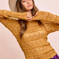 Mustard yellow textured sweater with scalloped hem and wide-brimmed hat