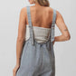 BiBi Patch vintage washed denim shortall with light-wash overalls and beige tank