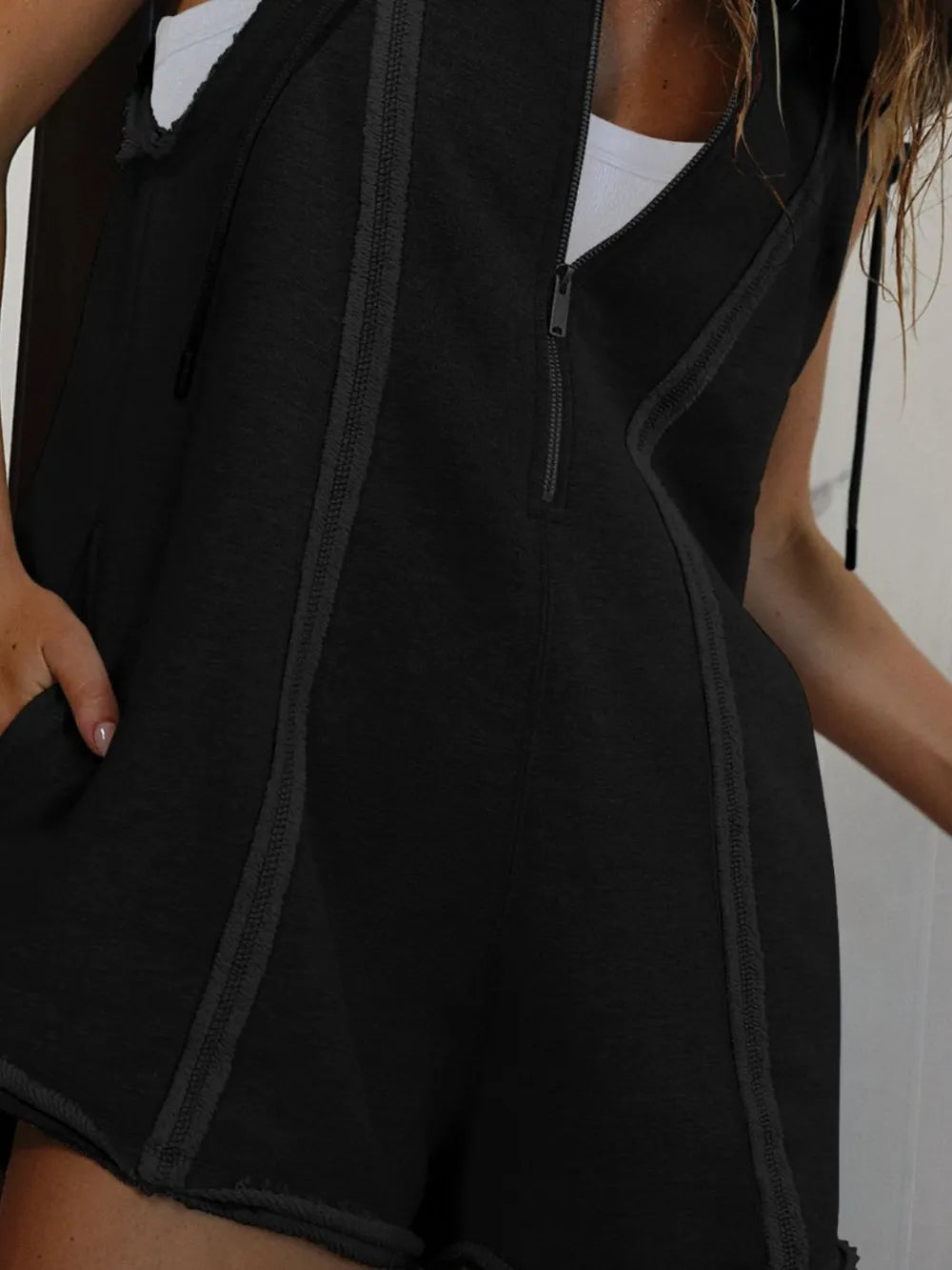Black sleeveless Half Zipped Hooded Romper with front zipper and textured trim