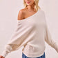 Cream-colored ribbed BiBi waffle knit off-shoulder top with flowing sleeves