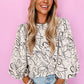 Woman in beige abstract print balloon sleeve crew neck blouse