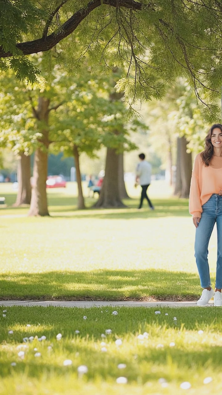 Video of a woman walking in a loose fit sweater