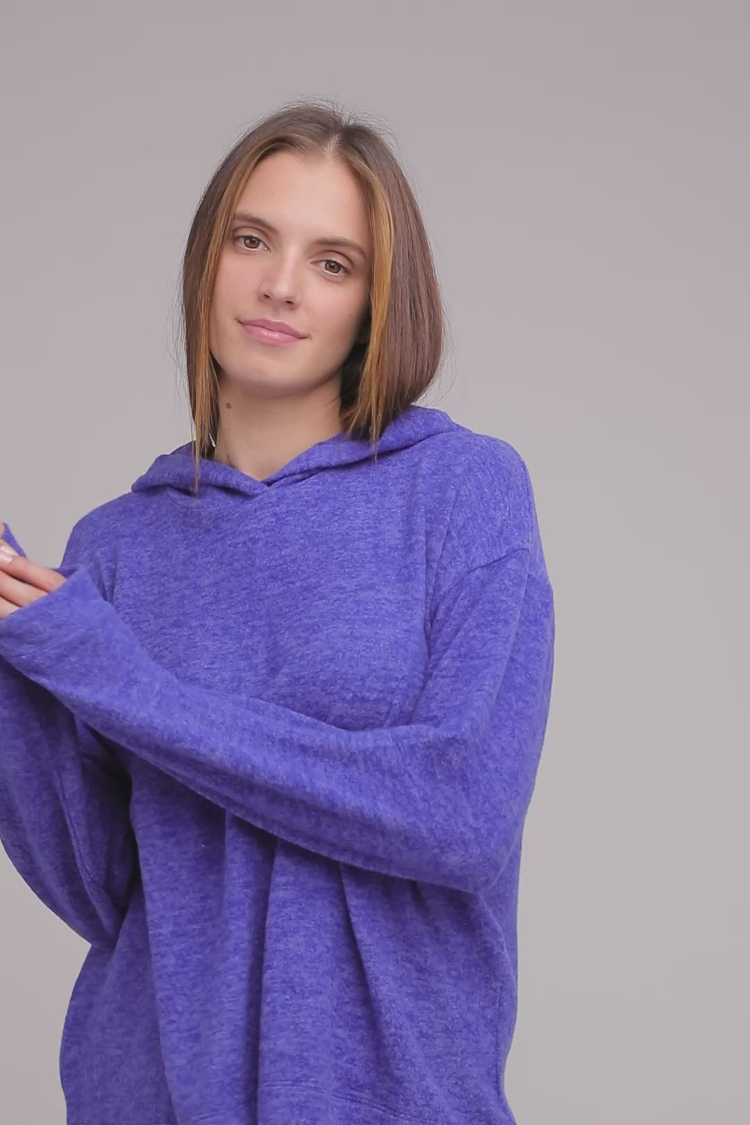 A video of a woman wearing a Zenana Hi Low Hem Hooded Melange Sweater in Blue | DAVERRI FASHIONS