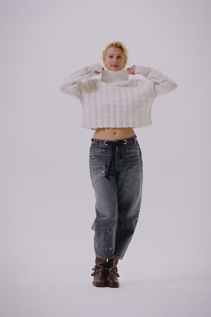 Video of a woman modeling a pair of denim barrel jeans