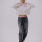 Video of a woman modeling a pair of denim barrel jeans