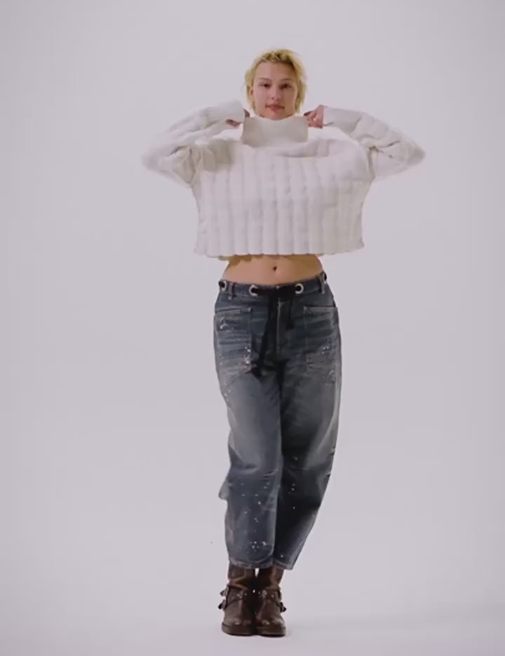 Video of a woman modeling a pair of denim barrel jeans