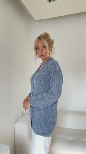 Video of woman modeling blue cardigan pocket sweater 