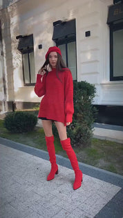 Video of a woman wearing a red mock neck loose fit sweater