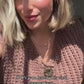 Woman in a video wearing sleeveless cardigan sweater vest