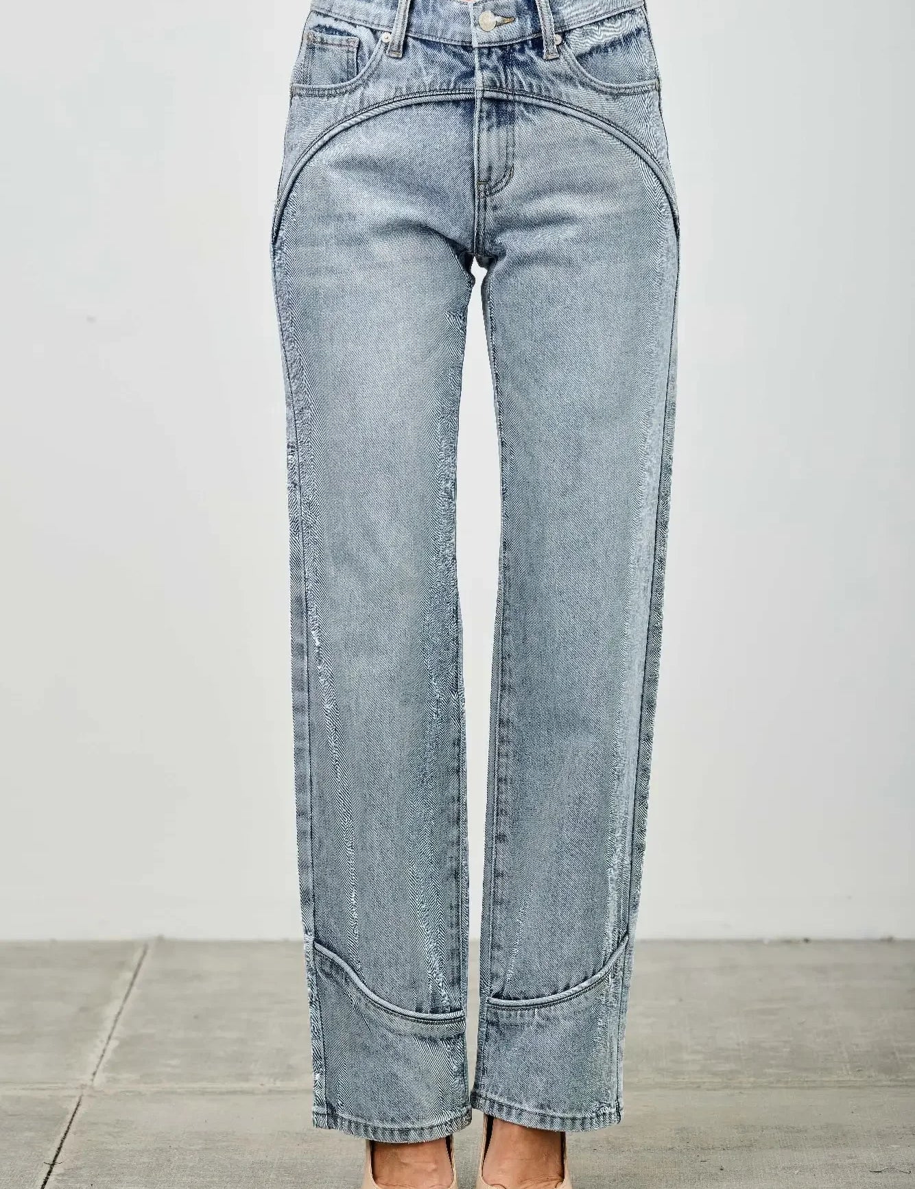 Light blue jeans worn by a person on a plain background